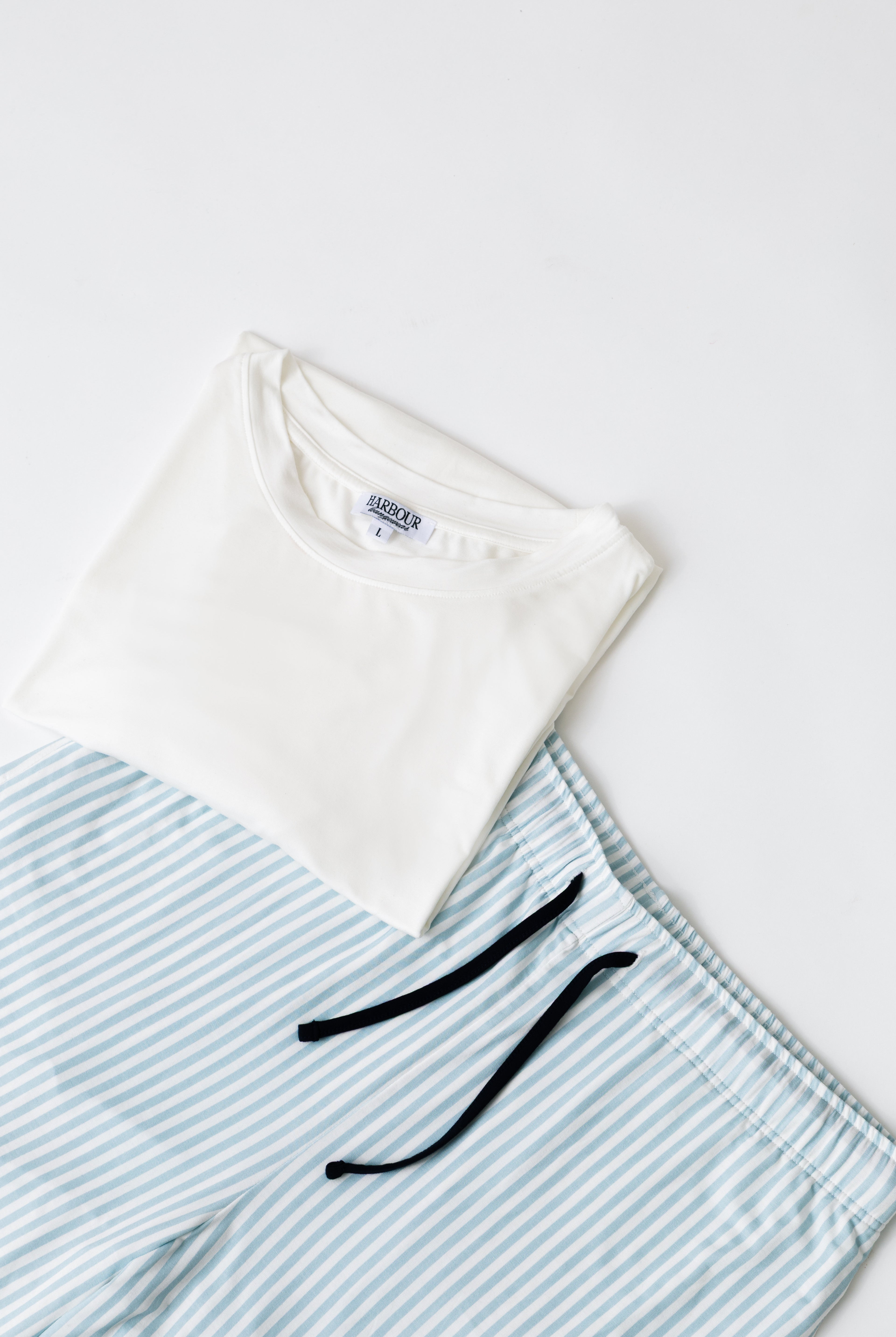 Blue striped modal shorts by Harbour with white modal T-shirt – relaxed men’s loungewear flat lay