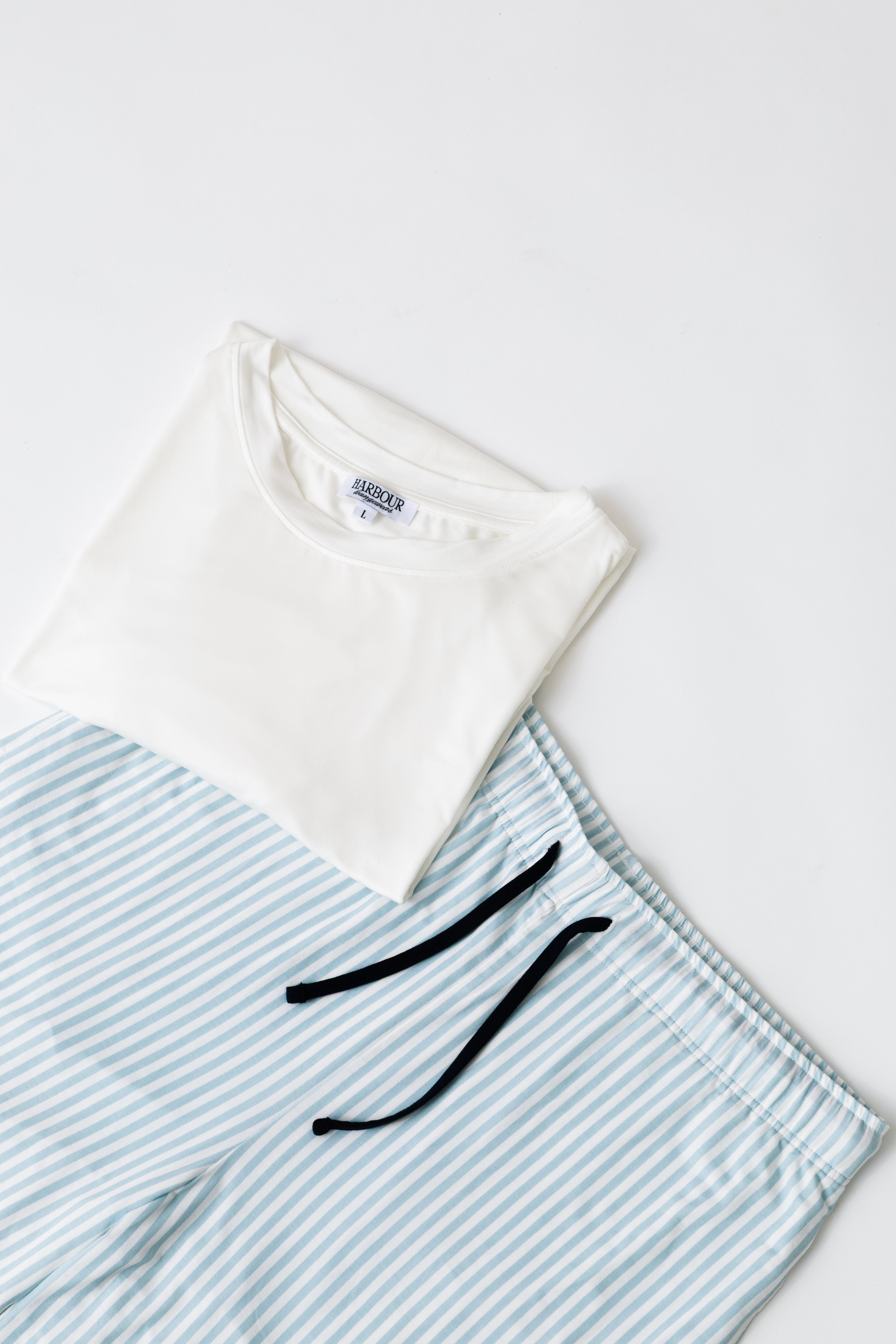 Blue striped modal shorts by Harbour with white modal T-shirt – relaxed men’s loungewear flat lay