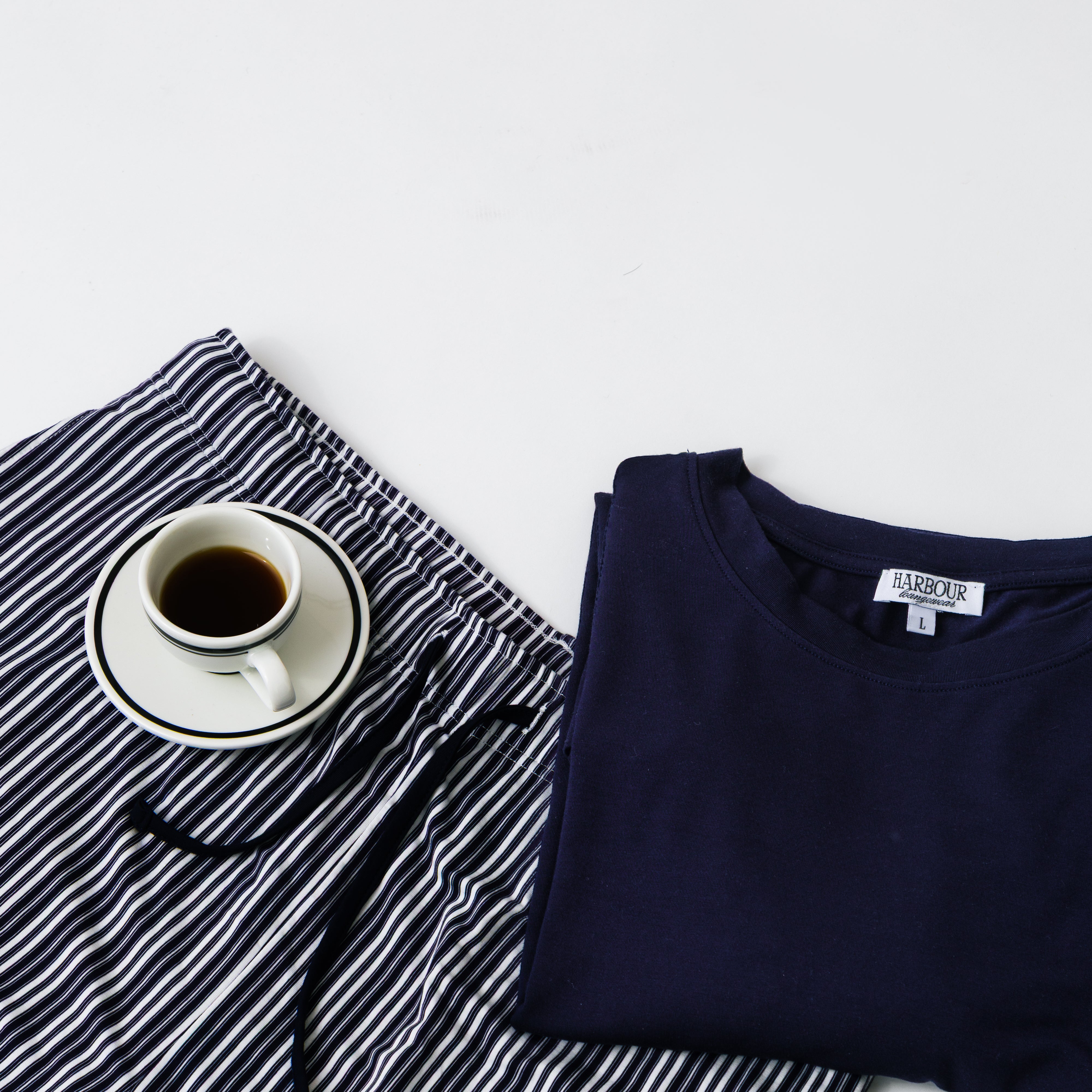 Harbour navy modal T-shirt and striped shorts with coffee cup – relaxed men’s loungewear flat lay