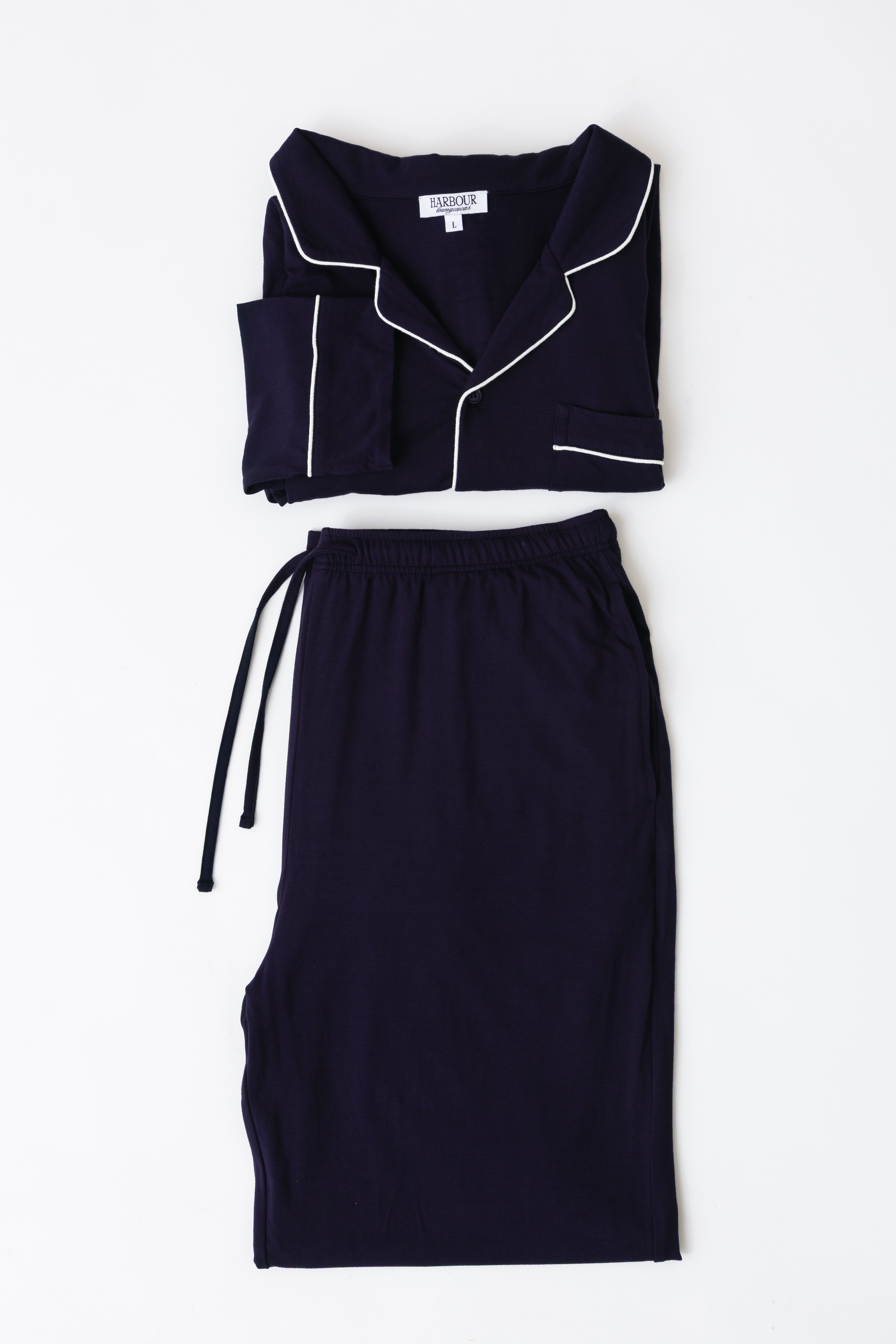 Navy men’s modal pajama set by Harbour – folded shirt and pants with white piping