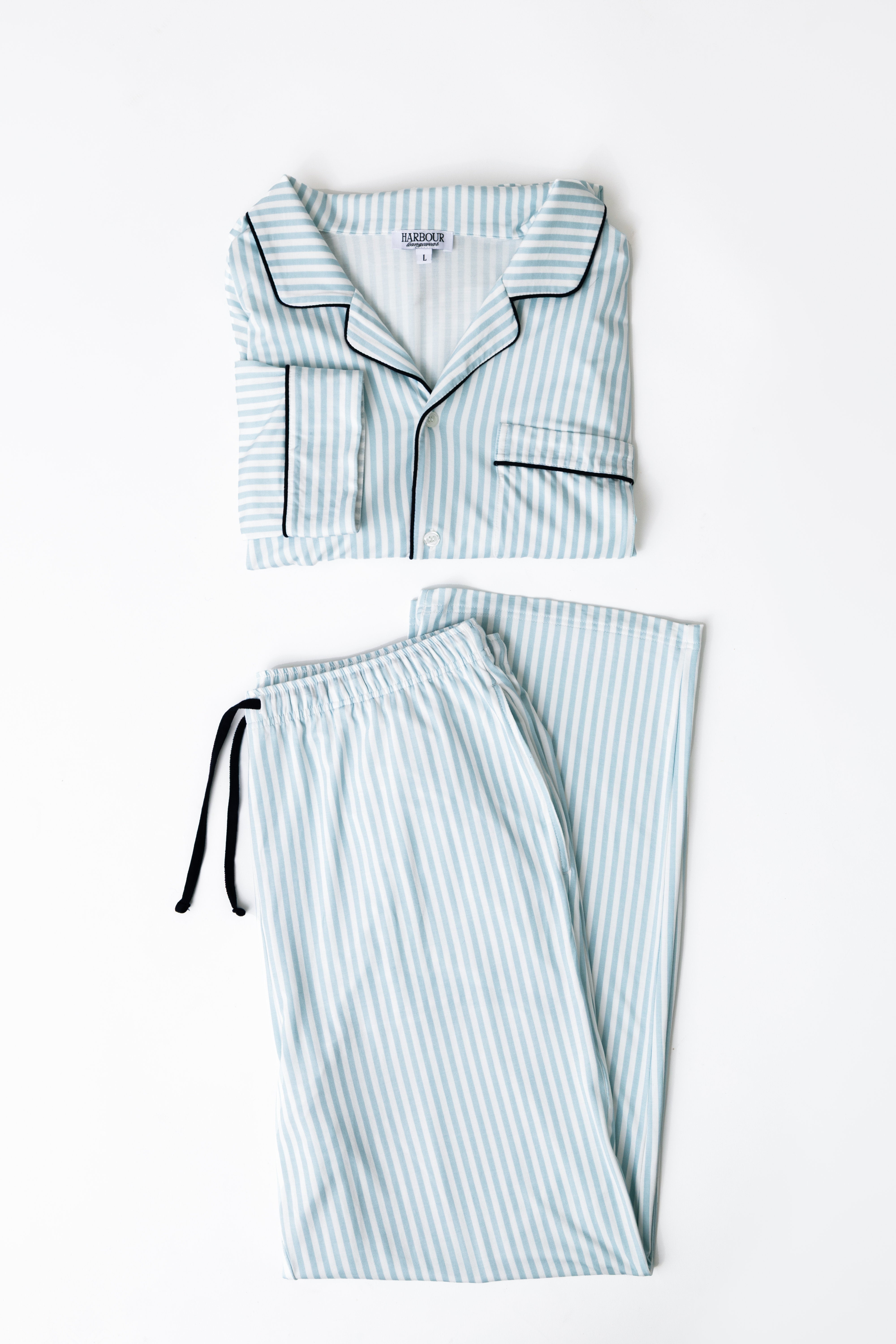 Striped modal pajama set by Harbour – folded shirt and pants with navy piping detail